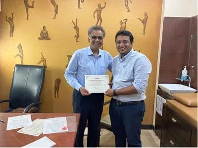 Dr. Yash Shah receiving a certificate