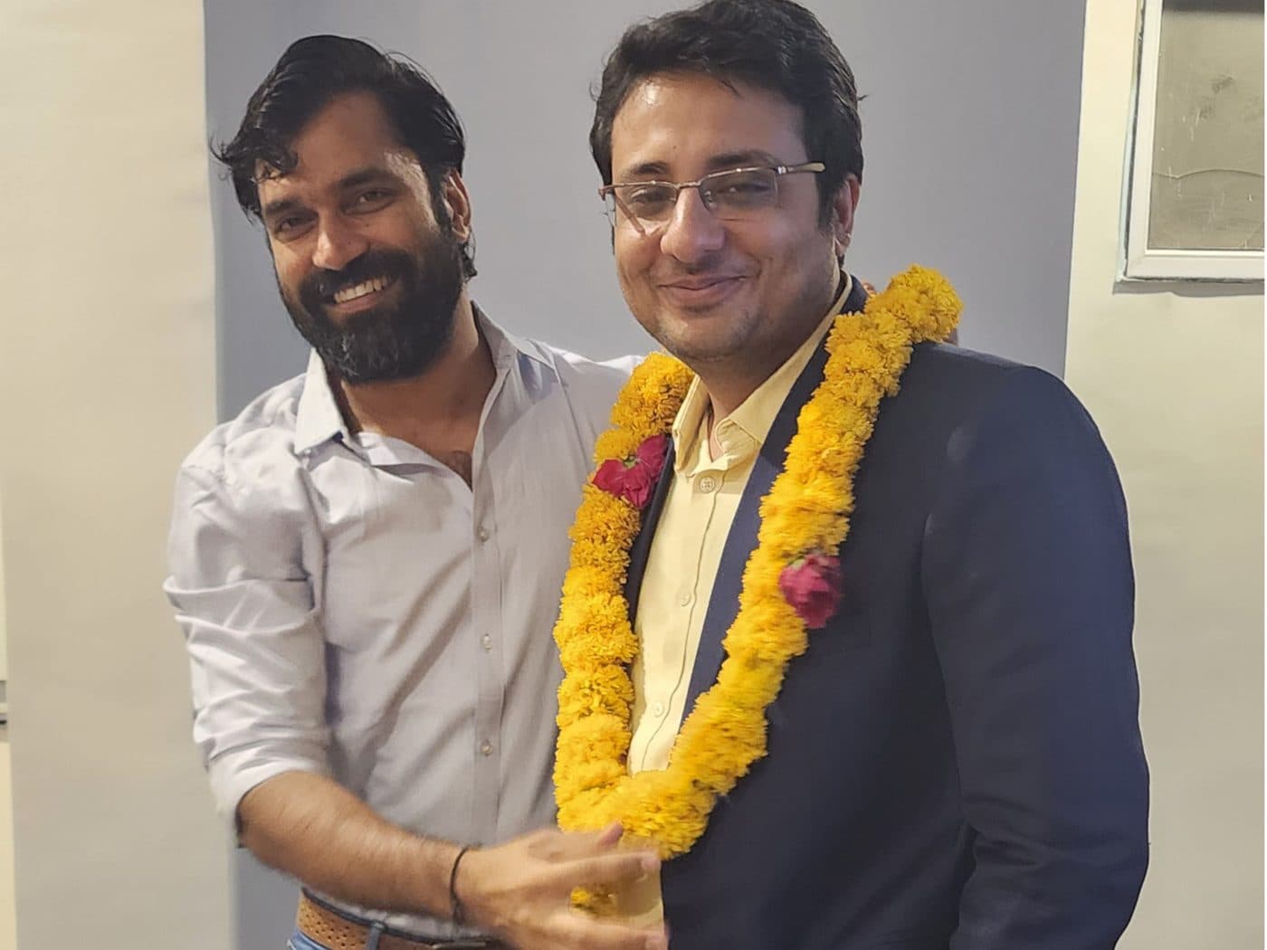 Dr. Yash Shah being felicitated with a marigold garland