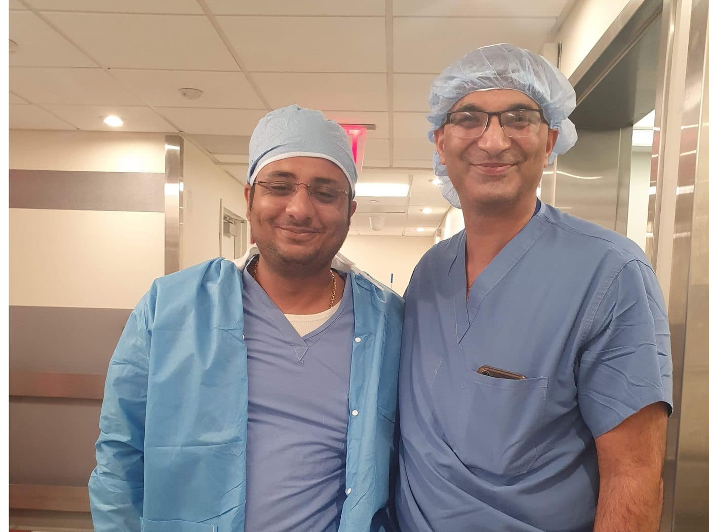 Dr. Yash Shah with a colleague in a hospital corridor